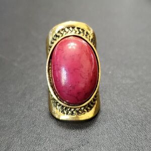 Gold tone ring with reddish purple faux stone Size 10